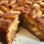 A freshly baked apple cake with cinnamon and nutmeg, perfect for fall desserts.