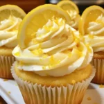 Lemon cupcakes with creamy vanilla buttercream and fresh lemon slices.