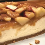 Slice of delicious homemade Apple Cheesecake topped with caramel and cinnamon