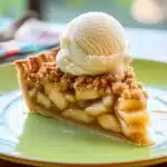 Delicious homemade Apple Crumble Pie with golden topping and juicy apples.