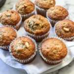 Delicious homemade Banana Nut Muffins on a wooden table