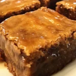 Delicious blondies topped with sweet maple glaze on a white plate