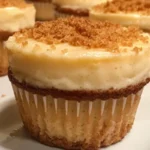 Delicious cheesecake cupcakes topped with creamy frosting and fresh berries.
