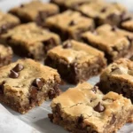 Delicious chocolate chip cookie bars on a wooden table