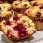 Freshly baked Cranberry Orange Muffins on a wooden table