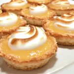 Mini lemon meringue tarts with a crispy crust and fluffy meringue topping