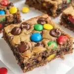 Delicious Monster Cookie Bars with oats, chocolate chips, and colorful candies.