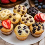 Delicious pancake muffins topped with syrup and berries on a plate