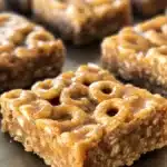 No-bake Peanut Butter Cheerio Bars cut into squares on a plate