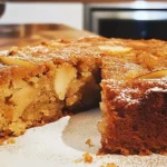 Slice of spiced pear cake with fresh ginger and cinnamon on a plate