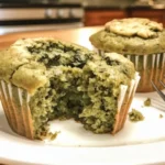 Freshly baked sweet spinach muffins on a cooling rack