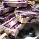 3 ingredient blueberry yogurt swirl popsicles ready to serve