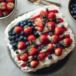 Delicious American Flag Cake decorated with berries and cream for a festive celebration.