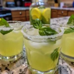 Basil Vodka Lemonade cocktail garnished with fresh basil and lemon slices