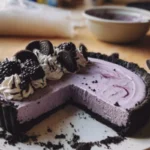 Delicious Blackberry Cheesecake Tart with a crispy Oreo crust on a white plate