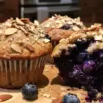Blueberry Almond Muffins freshly baked and arranged on a plate