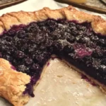 Homemade blueberry galette on a rustic wooden table
