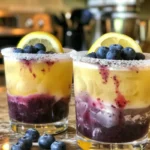 Chilled Blueberry Lemonade Cocktail garnished with fresh blueberries and lemon slices.
