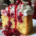 Delicious cherry cake topped with cherry sauce and whipped cream
