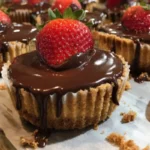 Chocolate covered strawberry cheesecake cups served in elegant dessert cups