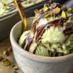Chocolate swirl pistachio ice cream in a bowl, featuring vibrant green and rich chocolate colors.