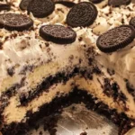Delicious Cookies and Cream Cake topped with chocolate shavings and cookie crumbles.