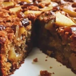 Delicious slice of Date Pear Cake with fresh dates and pears on a plate.