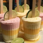 Frozen mango strawberry margarita pops served in colorful molds