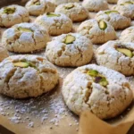 Plate of gluten-free pistachio cookies with a sprinkle of nuts on top