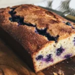 Slice of Greek Yogurt Apple Blueberry Bread topped with fresh fruits.