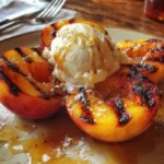 Delicious grilled peaches topped with vanilla ice cream in a bowl