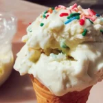 Bowl of creamy homemade ice cream topped with fresh fruit