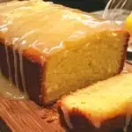 Sliced iced lemon pound cake showcasing a moist texture and lemon glaze