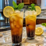 Iced Tea Lemonade Cocktail in a glass with fresh lemon slices