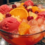Colorful Juneteenth Punch in a vibrant glass with fruit garnishes.