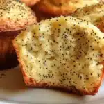 Freshly baked lemon poppy seed muffins on a wooden table