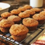Mini Cinnamon Sugar Pumpkin Muffins with cinnamon sugar topping on a wooden table
