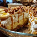No-Bake Banana Caramel Pecan Pie topped with pecans and banana slices