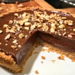 Nutella Tart with a toasted hazelnut crust garnished with chocolate drizzle