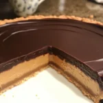 Delicious Peanut Butter Cup Tart topped with chocolate and peanut butter