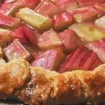 Delicious rhubarb galette with frangipane filling on a rustic wooden table