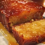 Sticky orange marmalade cake topped with golden syrup and orange slices.