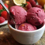 Bowl of homemade strawberry raspberry sorbet garnished with fresh berries