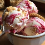 Bowl of strawberry cashew ice cream topped with fresh strawberries