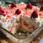 Delicious Strawberry Crunch Poke Cake with whipped cream and crunchy topping