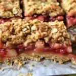 Delicious homemade strawberry rhubarb bars on a wooden table