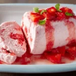 Delicious strawberry semifreddo garnished with fresh strawberries and mint leaves.