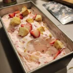No-churn strawberry shortcake ice cream served in a bowl with fresh strawberries