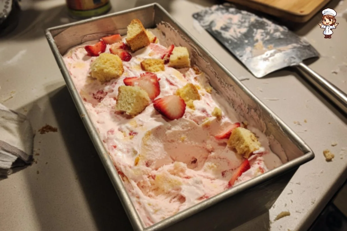 No-churn strawberry shortcake ice cream served in a bowl with fresh strawberries