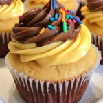 Delicious yellow birthday cupcakes decorated with colorful frosting and sprinkles